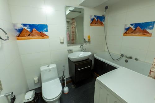 a bathroom with a white toilet and a sink at BNM Base Camp - Ulaanbaatar in Ulaanbaatar