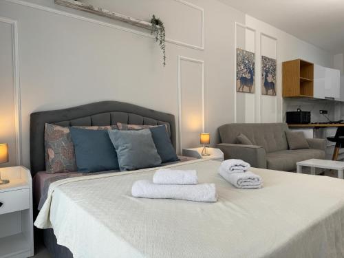 a bedroom with a bed with towels on it at Caesar Blue Collection Nothern Cyprus Studios & Spa Resort in Kaimakli