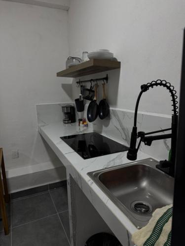 a kitchen counter with a sink and a faucet at Freya studio IV Romantic Zone in Puerto Vallarta