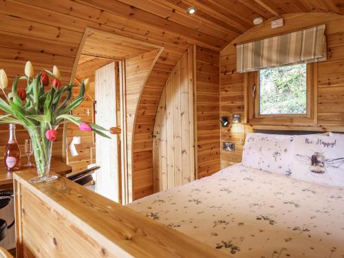 a bedroom with a bed in a log cabin at The Rhiw in Newtown
