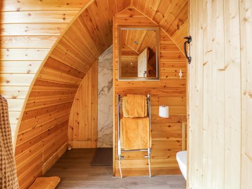 an attic bathroom with a circular staircase in a wooden house at The Rhiw in Newtown
