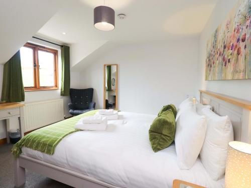 a bedroom with a large white bed with white pillows at High Dow Crag in Coniston
