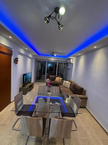 a living room with a table and a couch at 777 Stars in Paphos