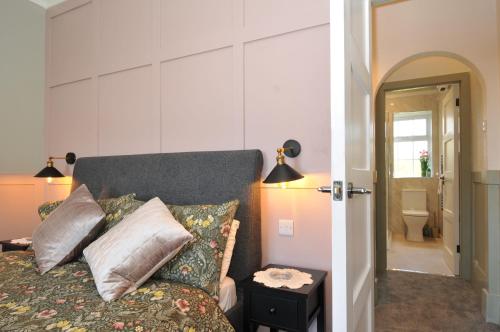 a bedroom with a bed with pillows on it at Tor View Fourwinds in Okehampton