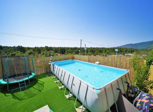 a swimming pool in a yard with chairs around it at נוף הרים בר יוחאי - בית נופש מדהים עם בריכה וג'קוזי in Bar Yohai