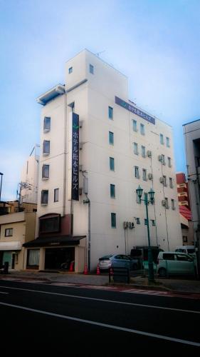a white building on the side of a street at Hotel Matsumoto Hills in Matsumoto