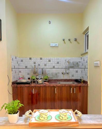 a kitchen with a table with two plates on it at TT Homes Private Studio Suites Jaipur Pink City in Jaipur