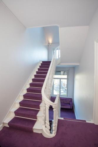 a staircase in a house with purple carpet at L'Esplanade Lille in Lille