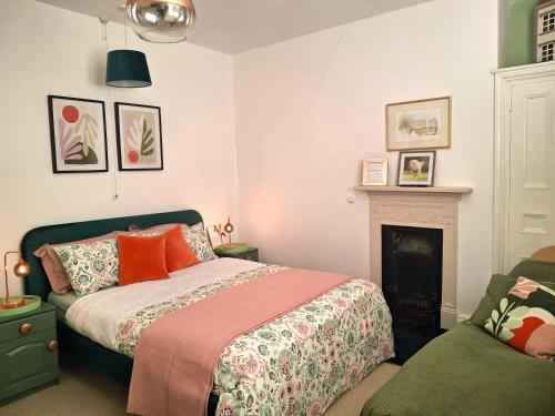 a bedroom with a bed and a fireplace at JESMOND House B&B room 1 in Hull
