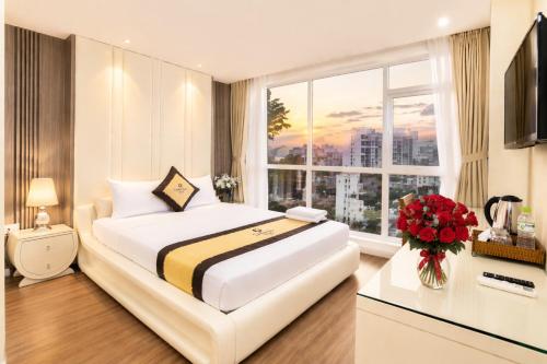 a hotel room with a large bed and a window at Golden Star Hotel in Ho Chi Minh City