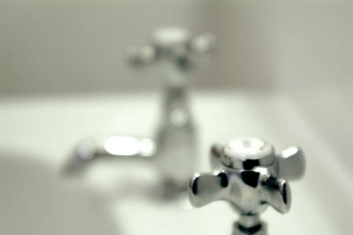 a black and white photo of a white and gray water faucet at The Tontine Hotel in Peebles