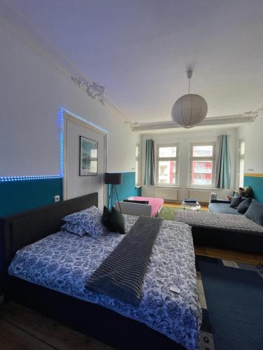 a bedroom with two beds and a living room at Urban Grand Suite in Berlin
