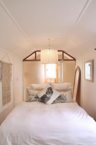 a bedroom with a large white bed with pillows at Mr Banks in Robe