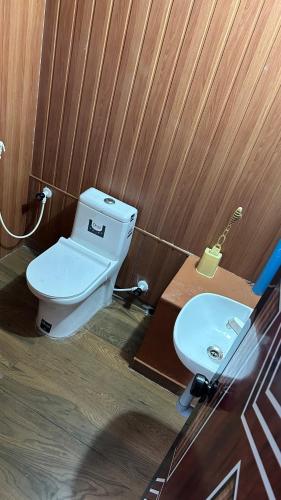a bathroom with a toilet and a sink at Athulya Tropical Paradise in Paravūr