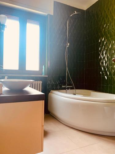 a bathroom with a bath tub and a sink at Villa Fiorentino in Ivrea