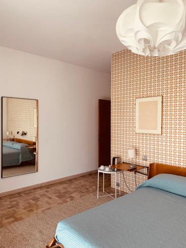 a bedroom with a bed and a mirror at Villa Fiorentino in Ivrea
