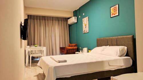 a bedroom with a bed and a blue wall at Lemon Garden in Antalya