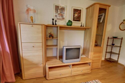a tv sitting on a wooden shelf in a room at Ferienwohnung Haus Rieder Inzell in Inzell