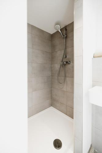 a shower with a shower head in a bathroom at Tiny Chalet in Blankenburg