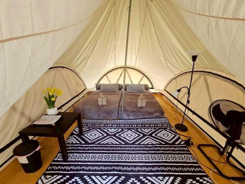 a bedroom with a bed in a tent at Nahm Khao Sok Hostel and Camping in Khao Sok National Park