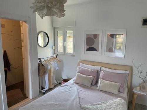 a bedroom with a bed with pink and white pillows at David 73 in Split