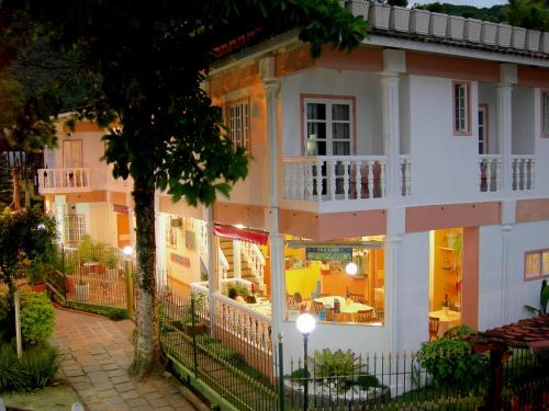 an apartment building with a balcony and a patio at Pousada Casablanca in Abraão
