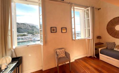 a room with a window with a view of a harbor at Le Régali par Dodo-a-Cassis in Cassis