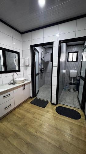 a bathroom with a shower and a sink and a toilet at Raza villa in Lautoka