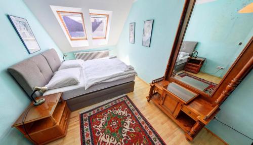 a living room with a couch and a mirror at Pension Siesta in Třeboň