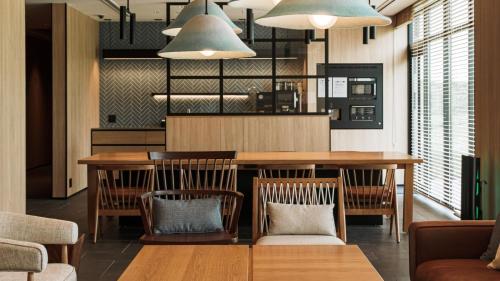 a dining room with a table and chairs at Fairfield by Marriott Hokkaido Naganuma in Naganuma