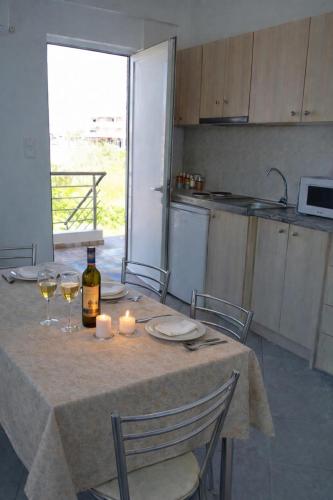 a kitchen with a table with glasses of wine and candles at Memories Studio in Neapoli Voion