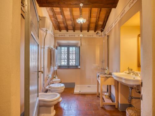 a bathroom with two toilets and a sink at Borgo Argenina in Monti di Sotto
