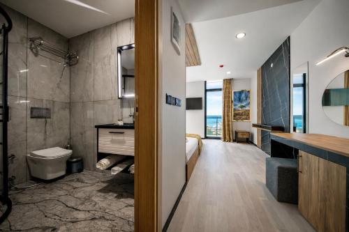 a bathroom with a shower and a toilet and a sink at Air Barbaros Hotel Trabzon in Trabzon