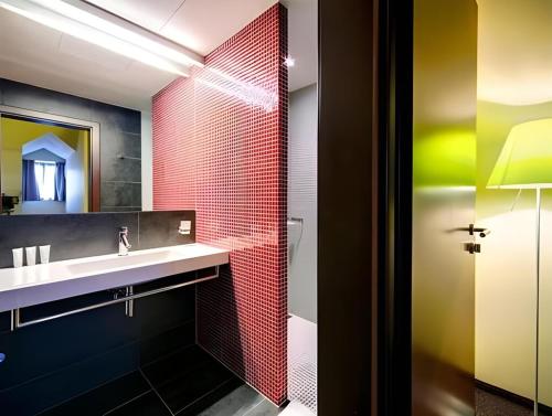 a bathroom with a sink and a mirror at Hotel Restaurant Darwin in Prague