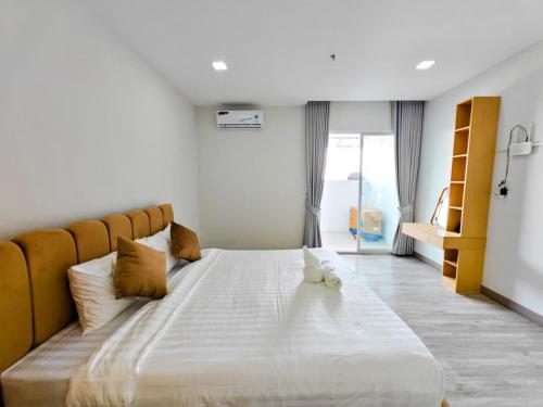 a large white bed in a room with a window at Tiffany Resident Apartment in Siem Reap