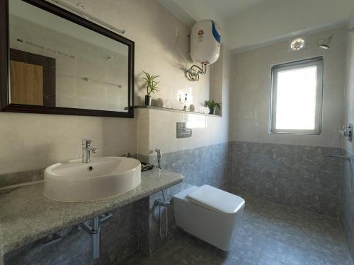 a bathroom with a sink and a toilet at Happy Villa Guest House in Guwahati