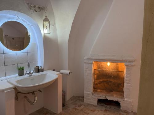 a bathroom with a sink and a fireplace at Patrick's Traditional Home in Pyrgi