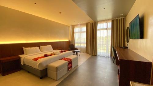 a hotel room with a bed and a desk at PAN HOTEL AND RESORT in Abucay