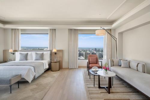 a bedroom with a bed and a couch at Trident Nariman Point in Mumbai