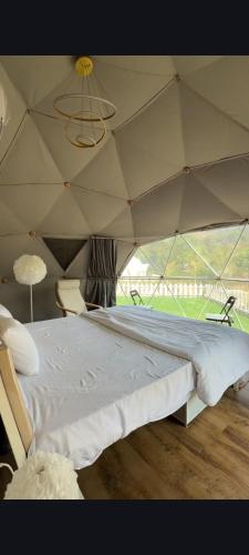a bedroom with a large bed in a tent at Harmony Hills in Bhīra Camp
