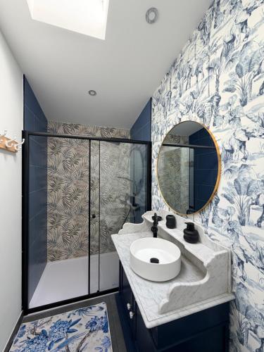 a bathroom with a sink and a mirror at Au bord de l'étang in Saint-Aubin