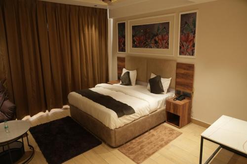 a bedroom with a large bed in a room at Vardaan Residency Hotel in Gorakhpur