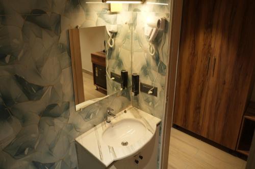 a bathroom with a sink and a mirror at Vardaan Residency Hotel in Gorakhpur