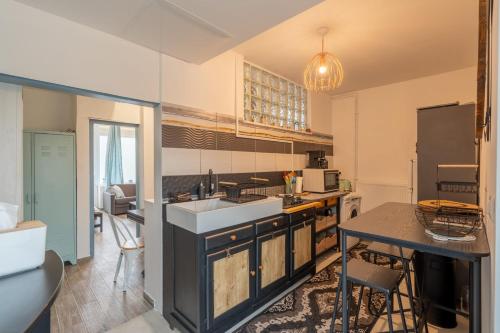 a kitchen with a sink and a counter top at Le Sostranien - Jardin - Wifi in La Souterraine