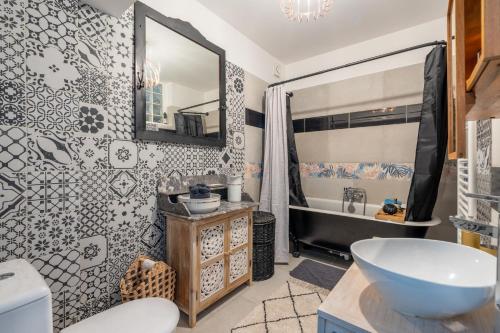 a bathroom with a sink and a mirror at Le Sostranien - Jardin - Wifi in La Souterraine