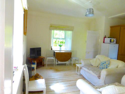 a living room with a couch and a table at Little Dunbar in Dumfries