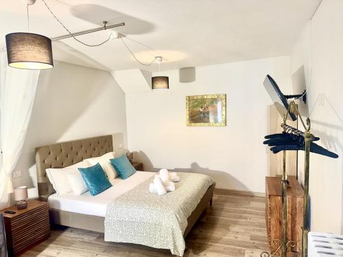 a bedroom with a bed with blue and white pillows at Laglio Cloud Nine, Como Lake in Laglio