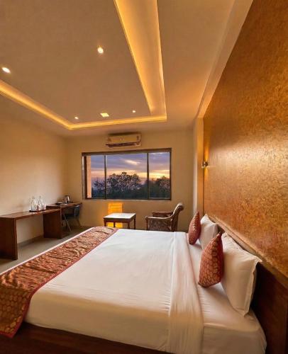 a hotel room with a bed and a window at Hotel Tania Searock in Daman