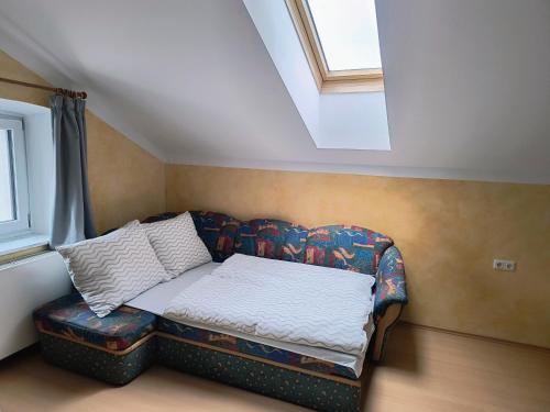 a couch sitting in a room with a window at Apartment Alpenblick Lienz in Lienz