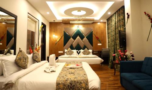 a hotel room with two beds and a couch at The Hoften Al Shaykh Resorts, Srinagar in Srinagar